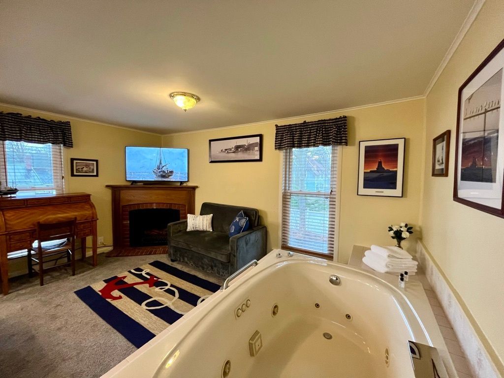 A living room with a jacuzzi tub and a fireplace.