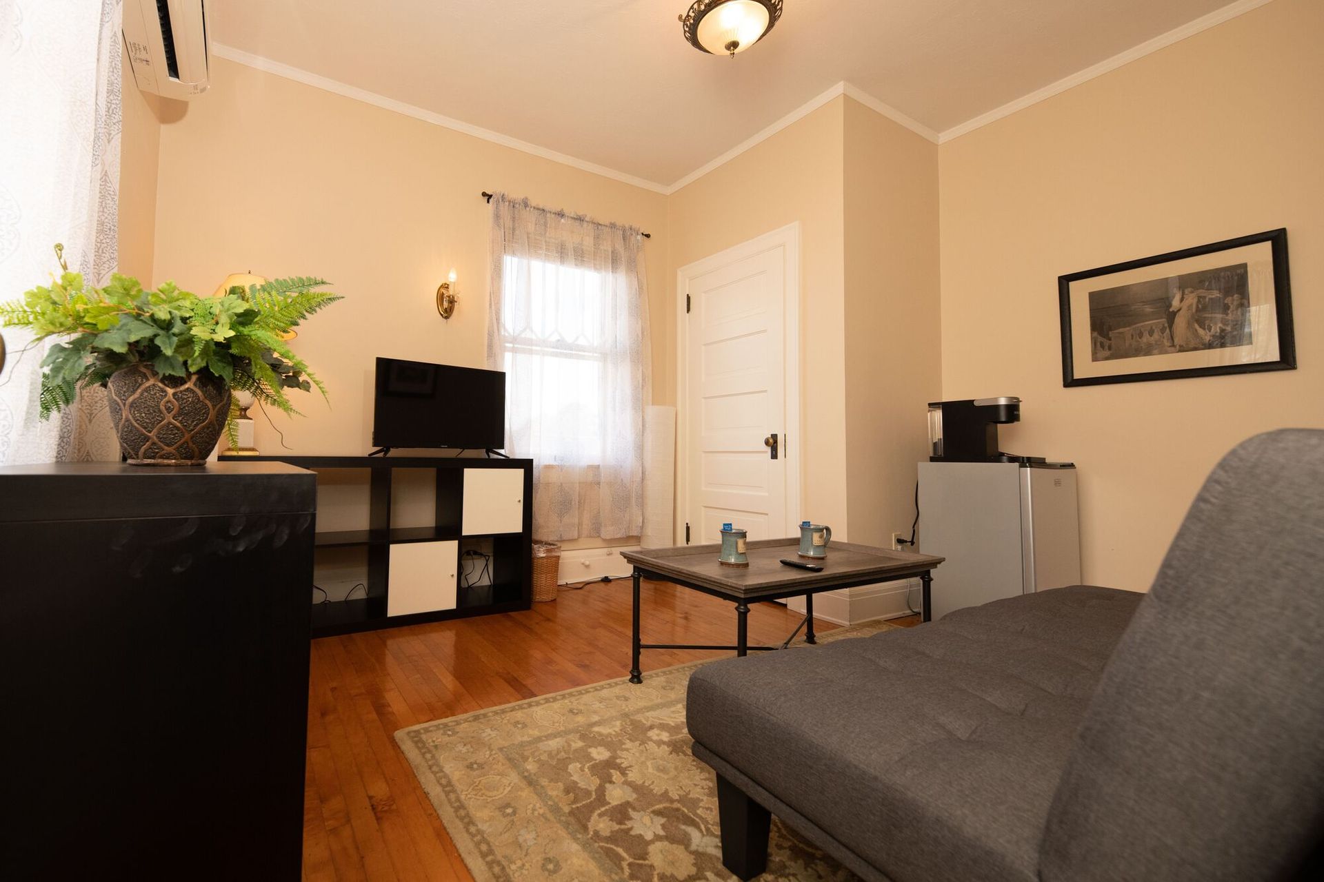 A living room with a couch a coffee table and a television