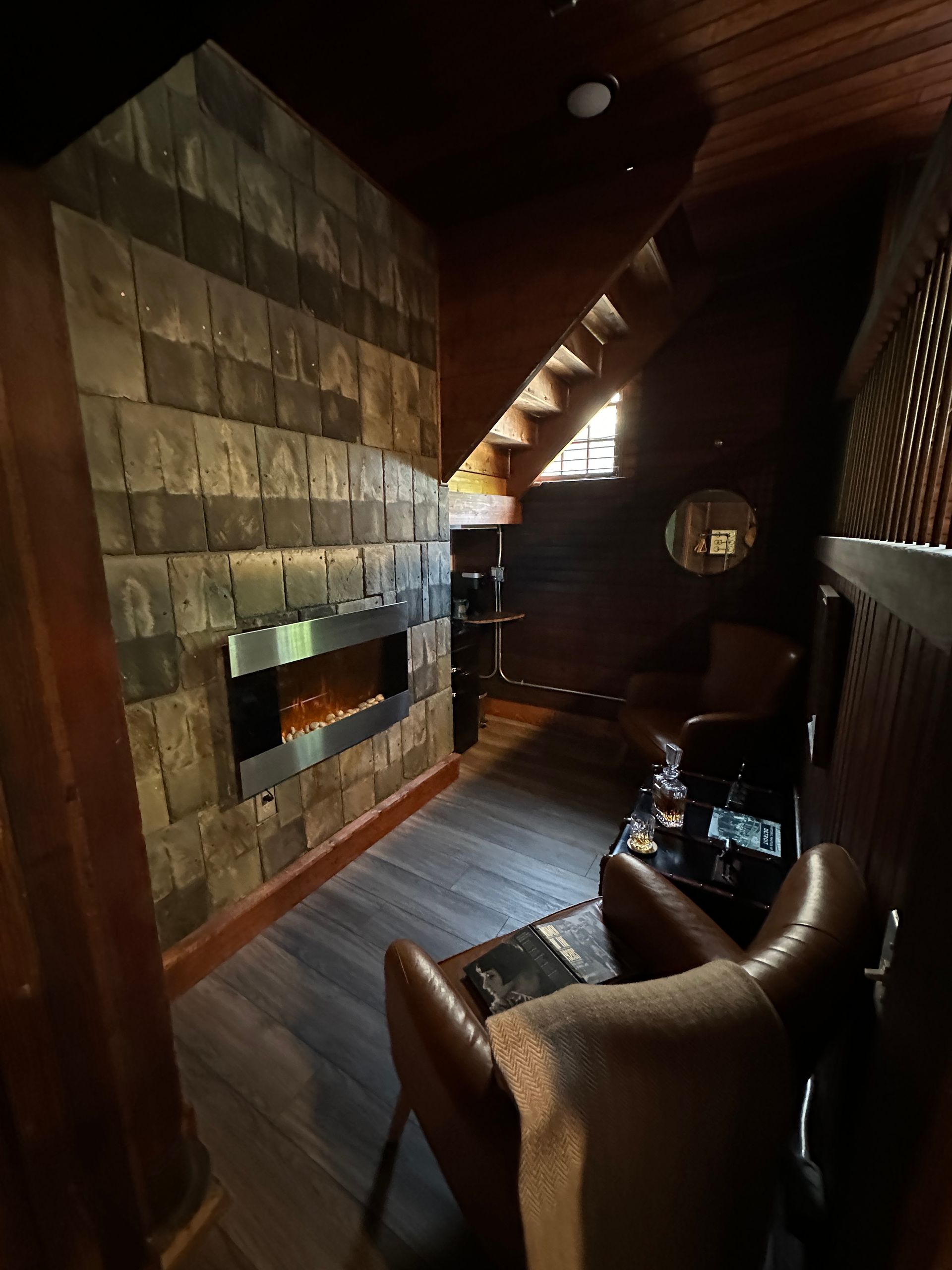 A living room with a fireplace and stairs