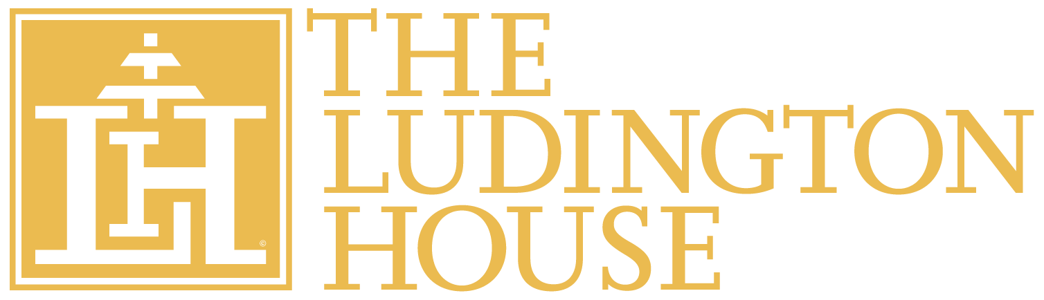 The logo for the ludington house is yellow and white.