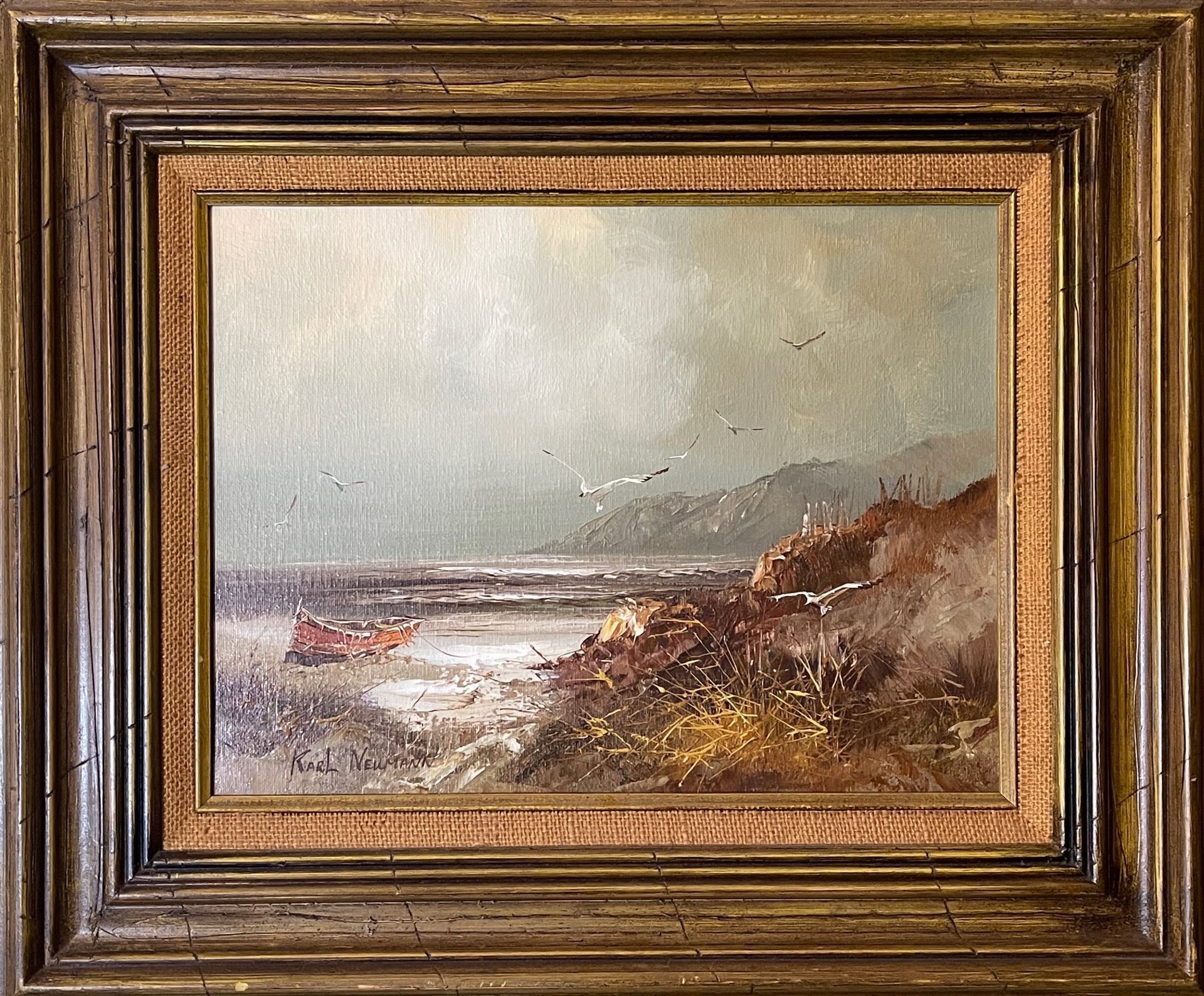 A framed painting of a boat in the ocean
