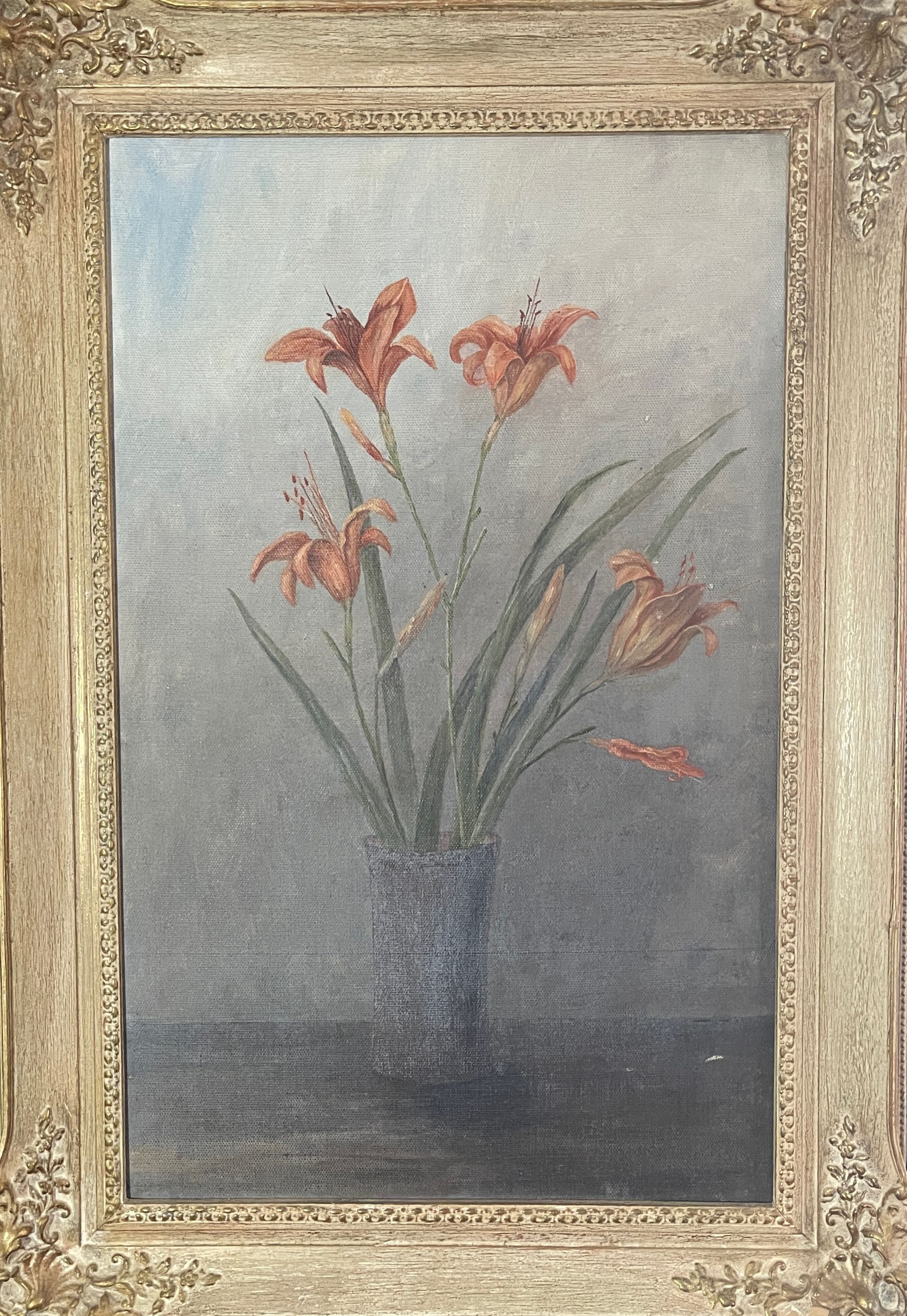 A painting of flowers in a vase on a table in a frame.