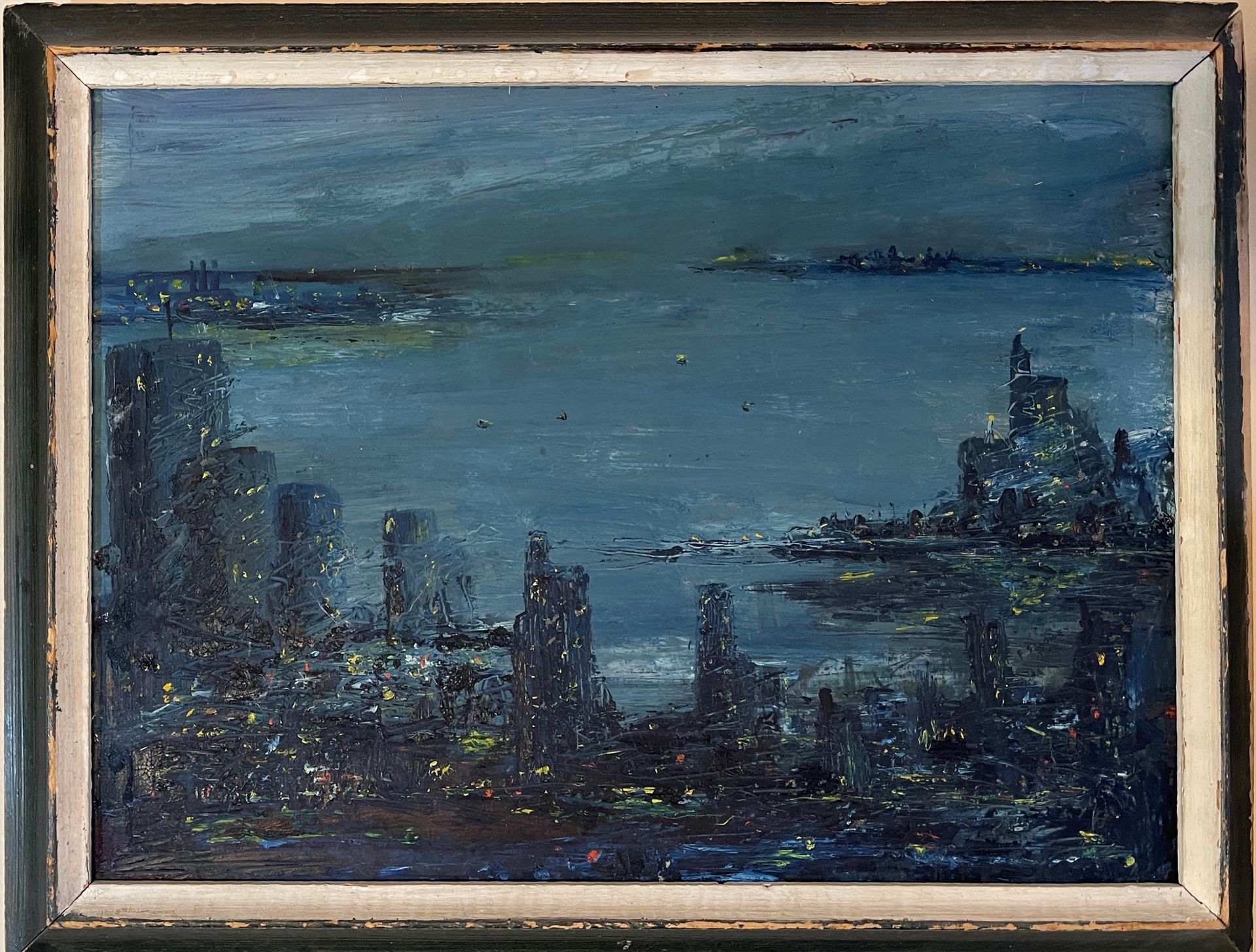 A framed painting of a city at night