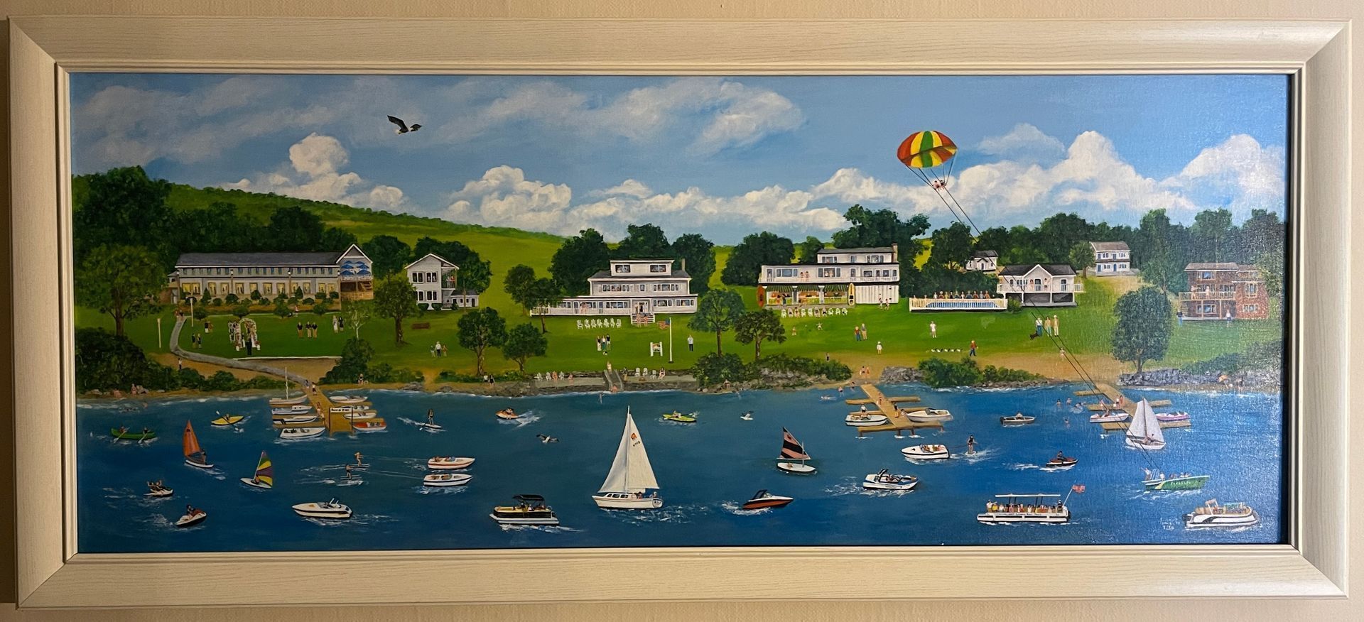 A painting of a lake with boats and a hot air balloon