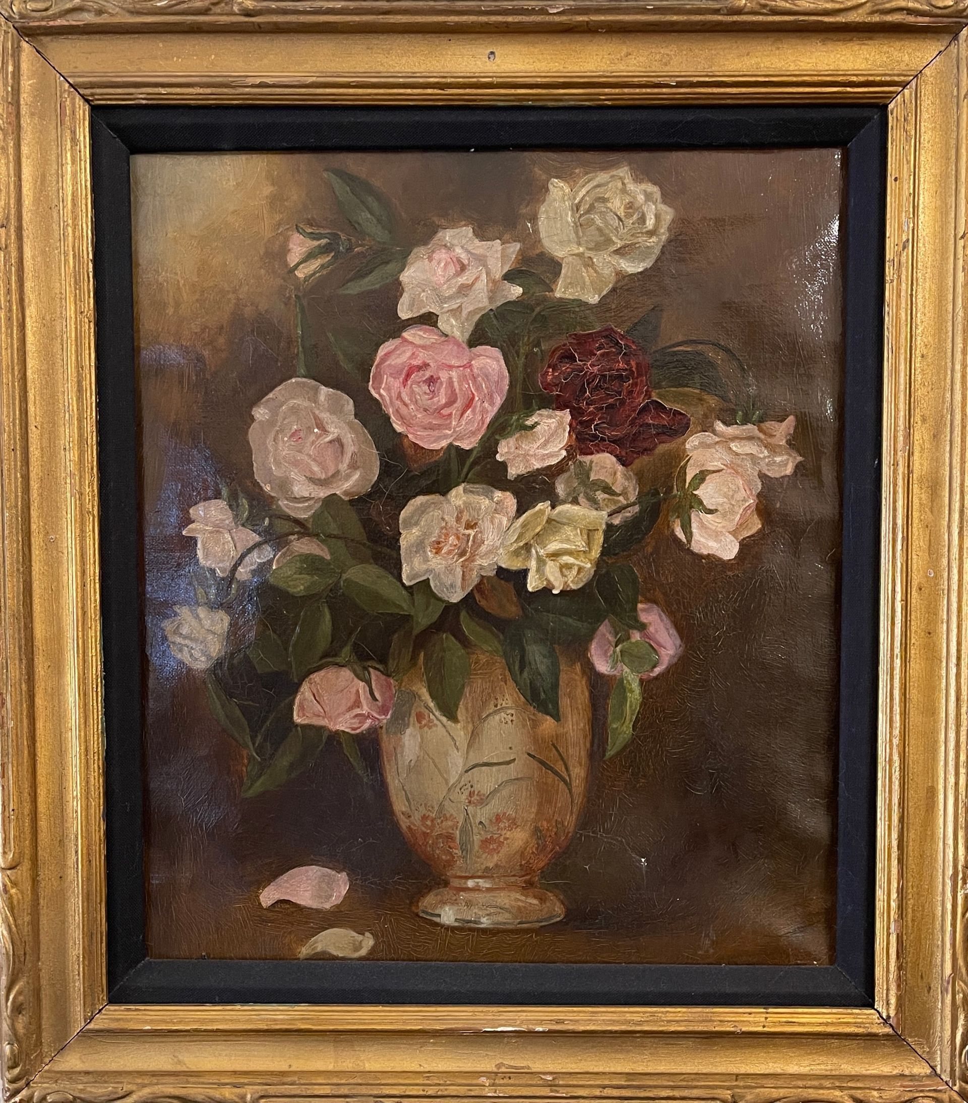 A painting of roses in a vase in a gold frame