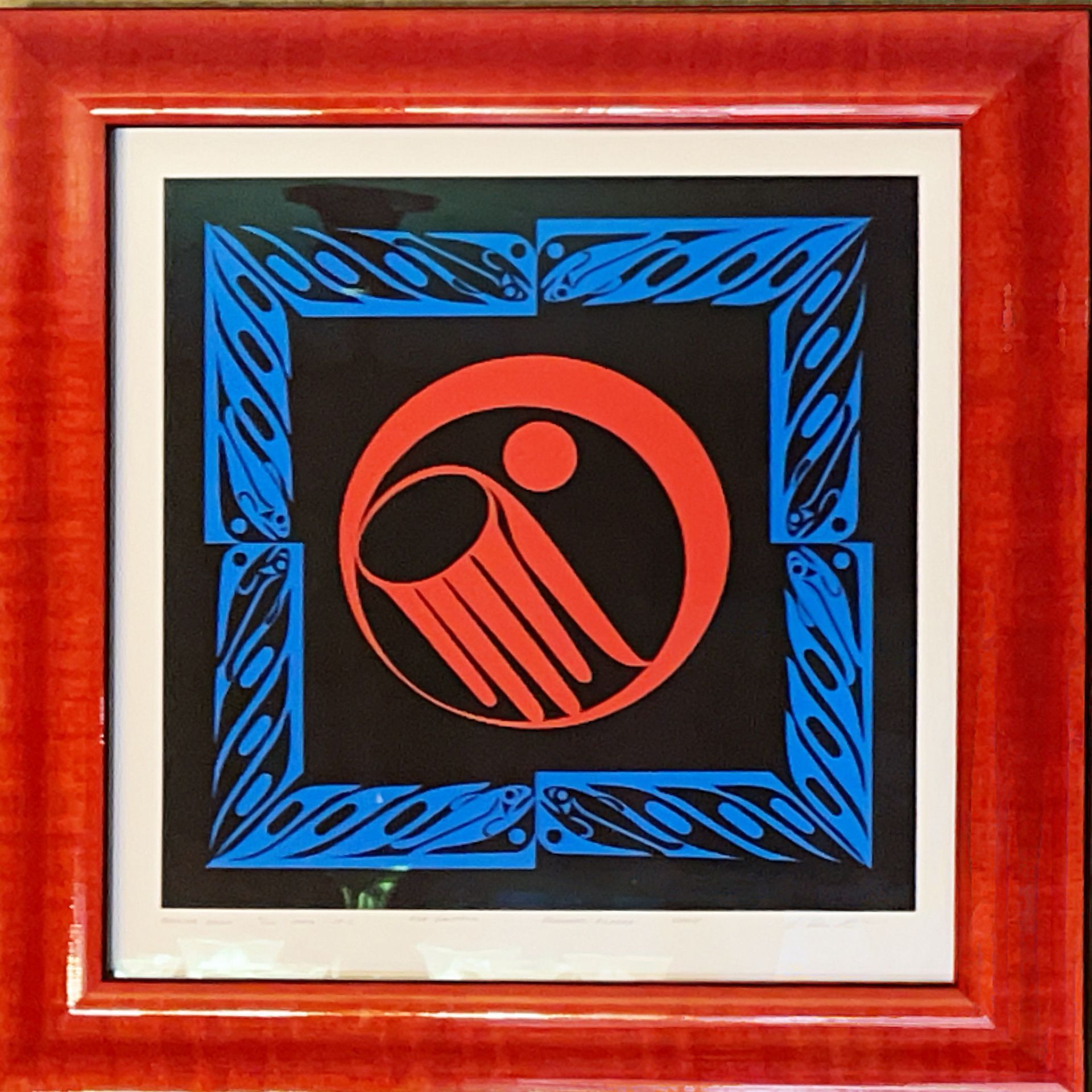 A picture in a red frame with a red circle in the middle
