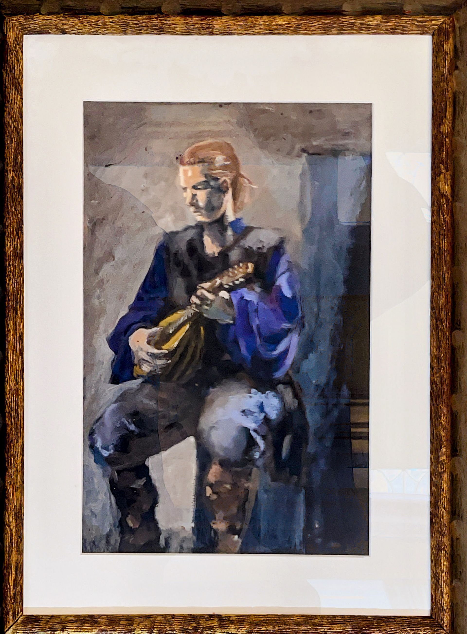 A framed painting of a man playing a guitar