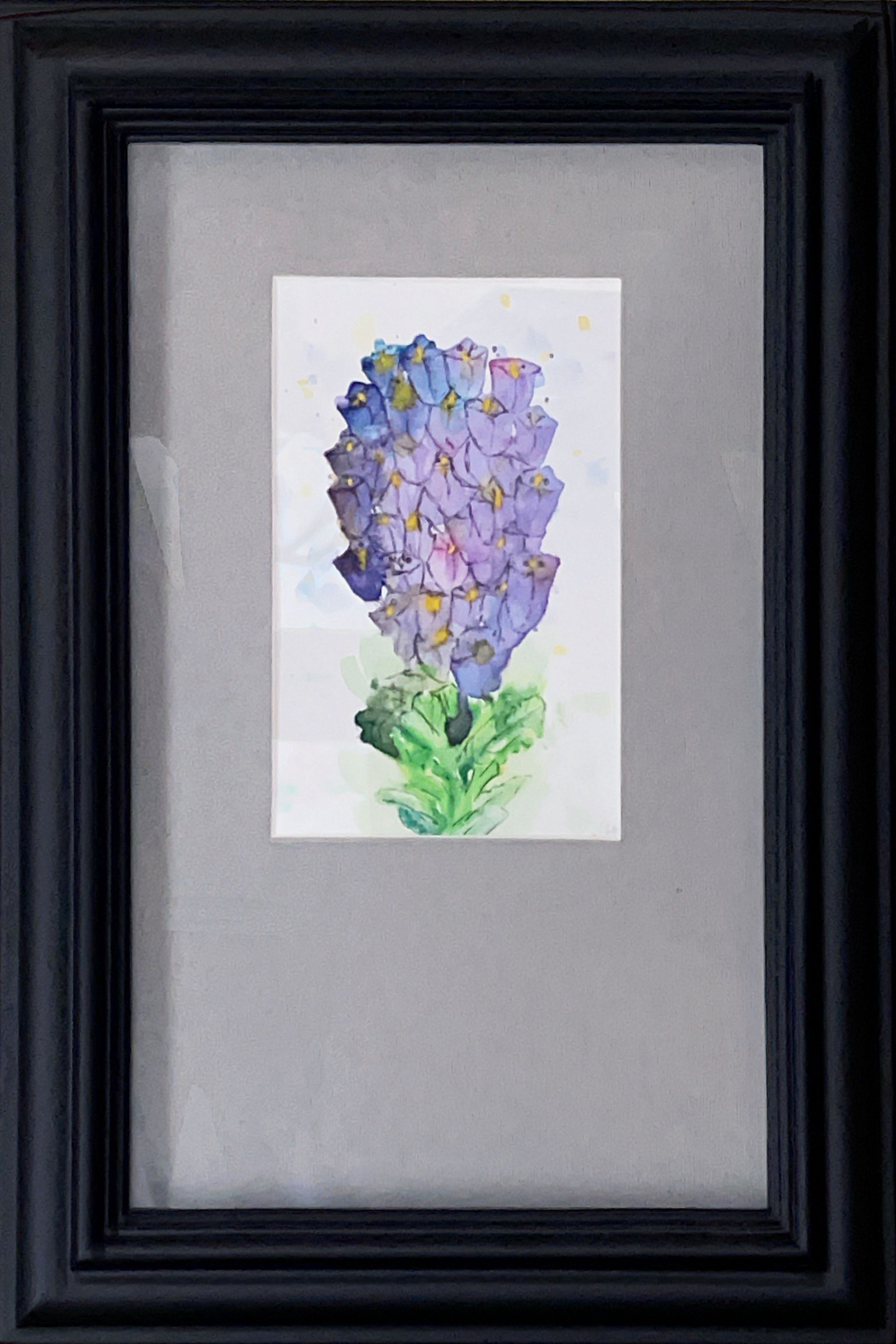 A painting of a purple flower in a black frame