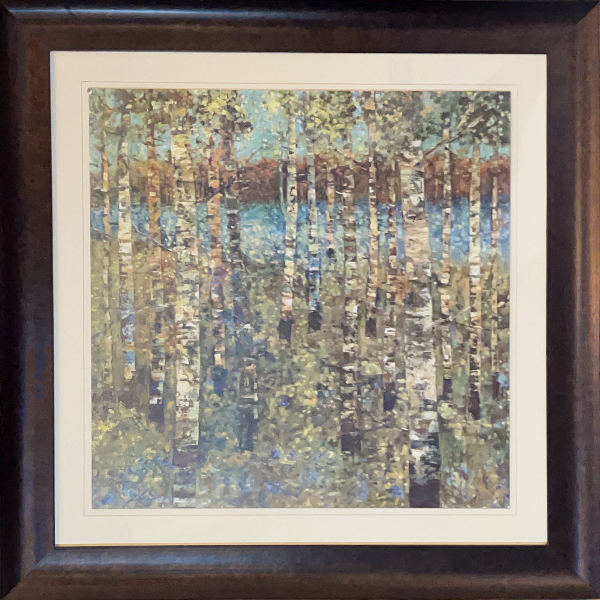 A framed painting of birch trees with a lake in the background