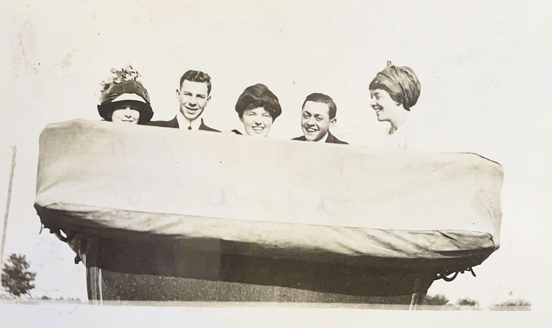 A black and white photo of a group of people in a boat