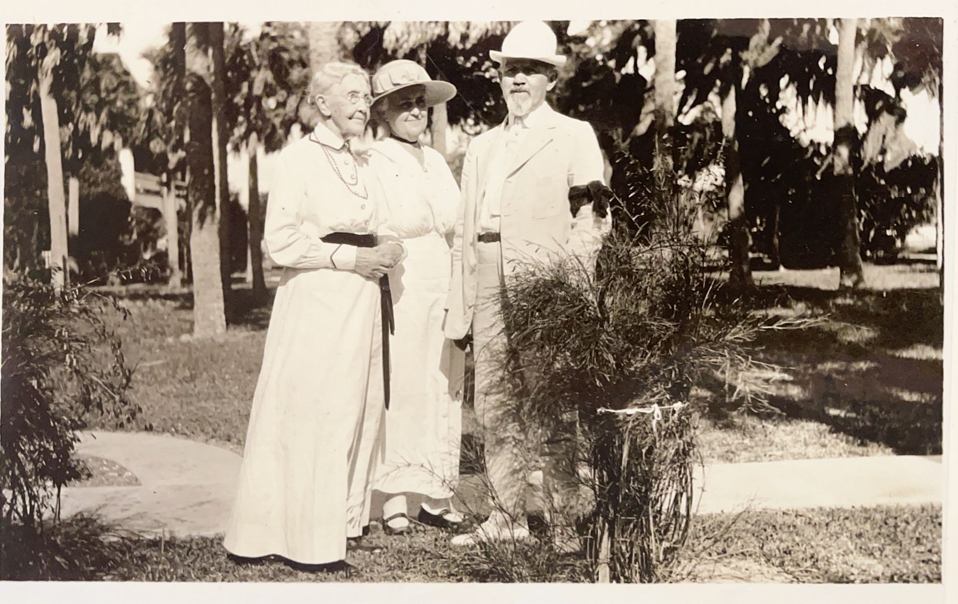 A black and white photo of three people standing next to each other