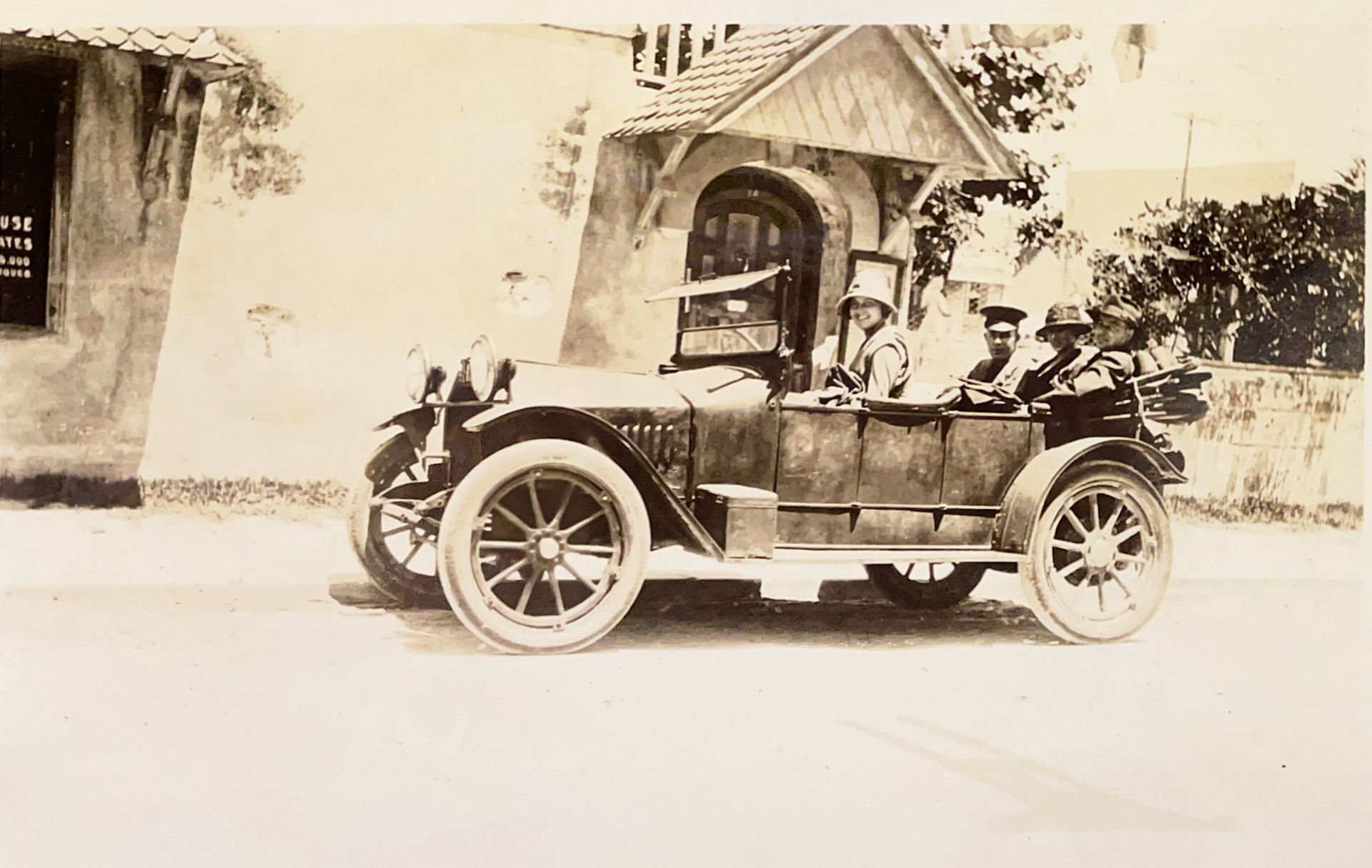 A black and white photo of a car driving down a road.