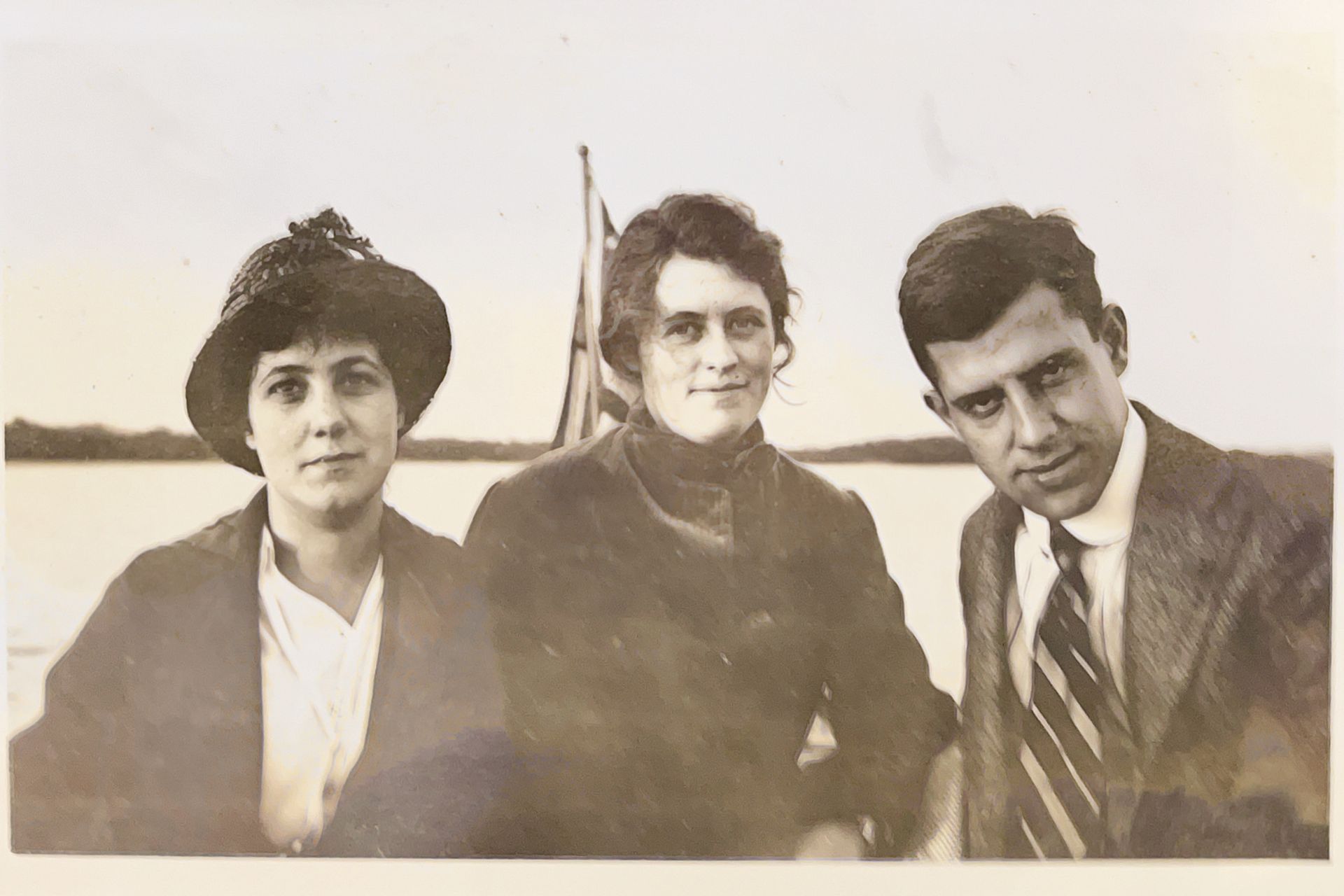 A black and white photo of three people standing next to each other