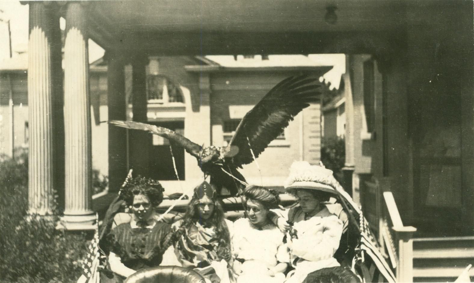 A black and white photo of a group of people and a bird