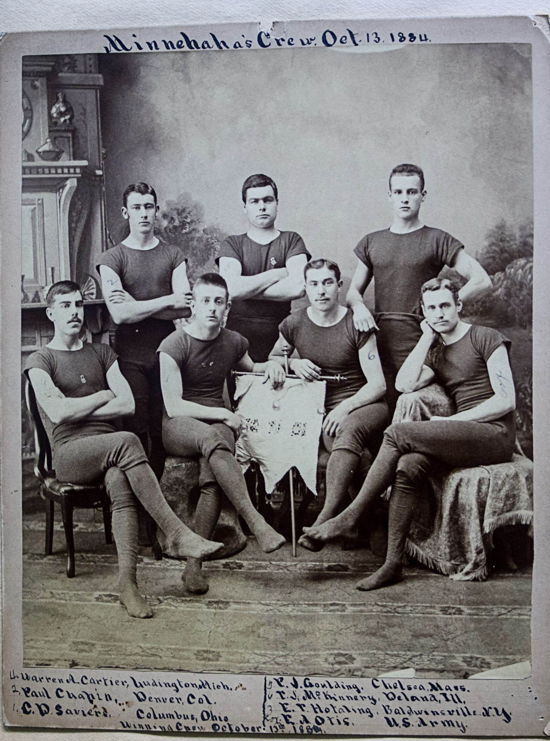 A group of men are posing for a picture and the date is october 12th