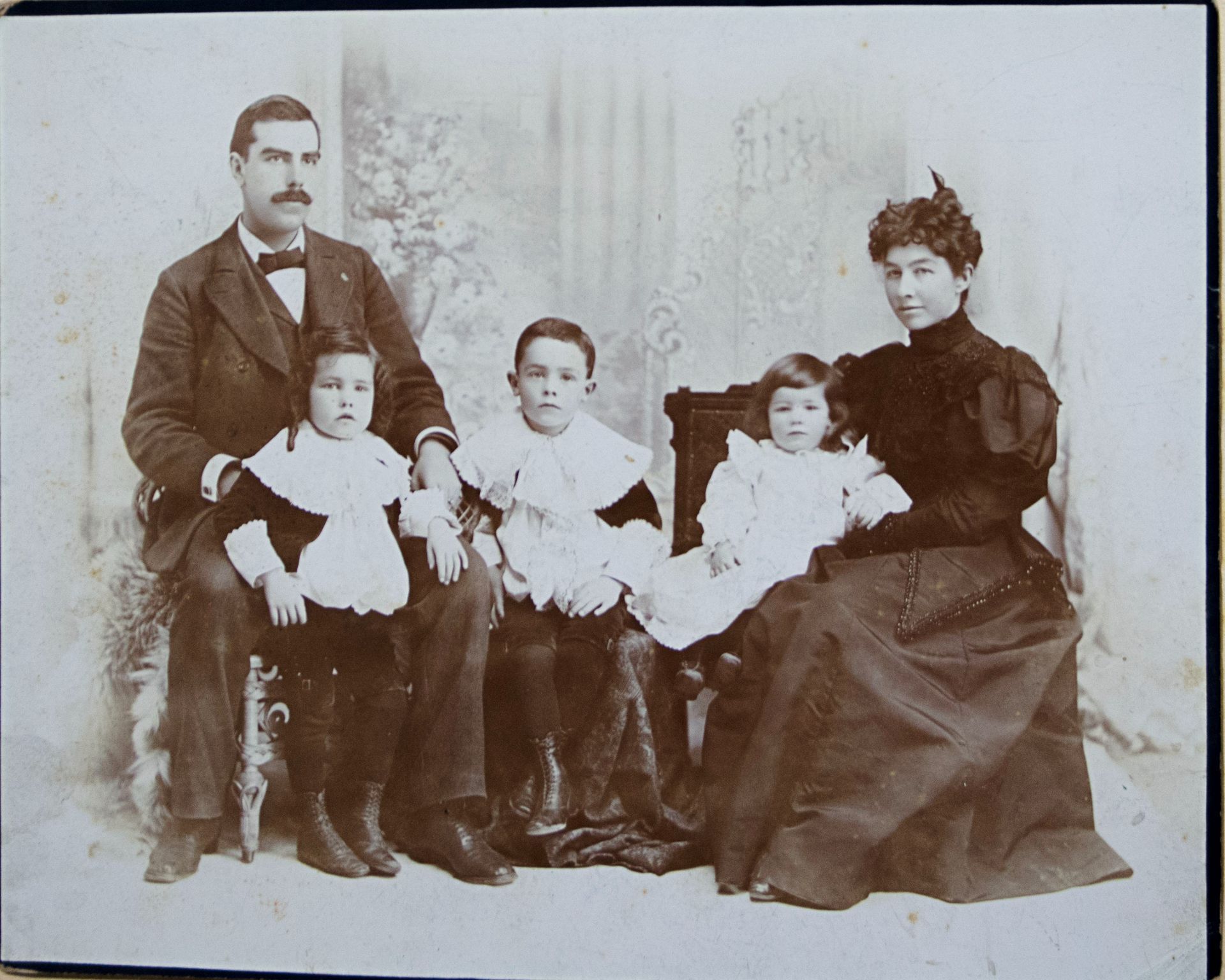 A black and white photo of a family posing for a picture