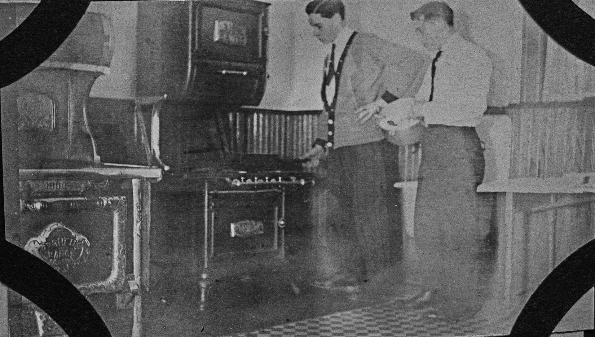 A black and white photo of two men standing next to each other