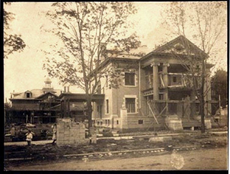 A black and white photo of a house under construction