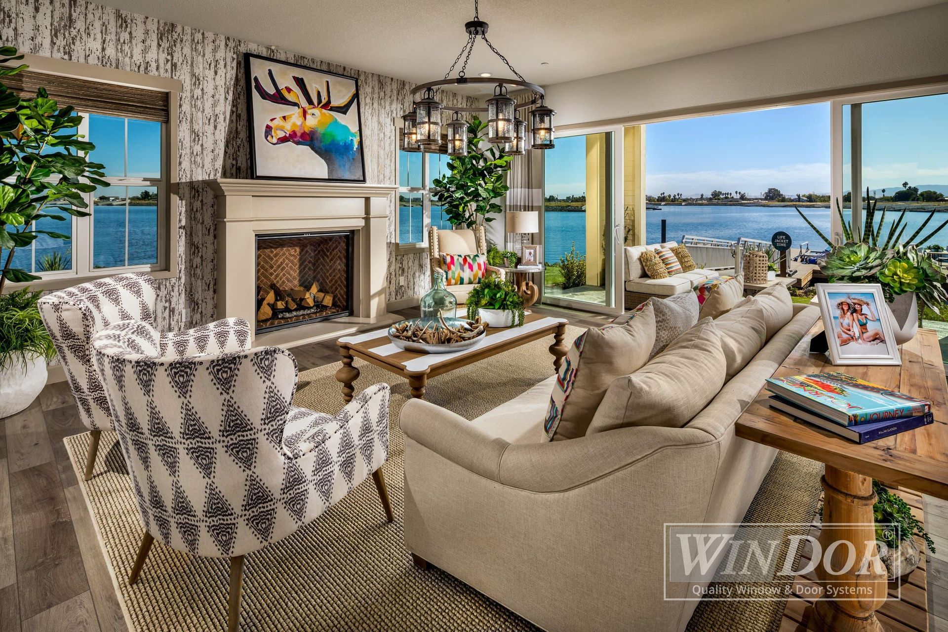 A living room with a couch , chair , coffee table and fireplace.