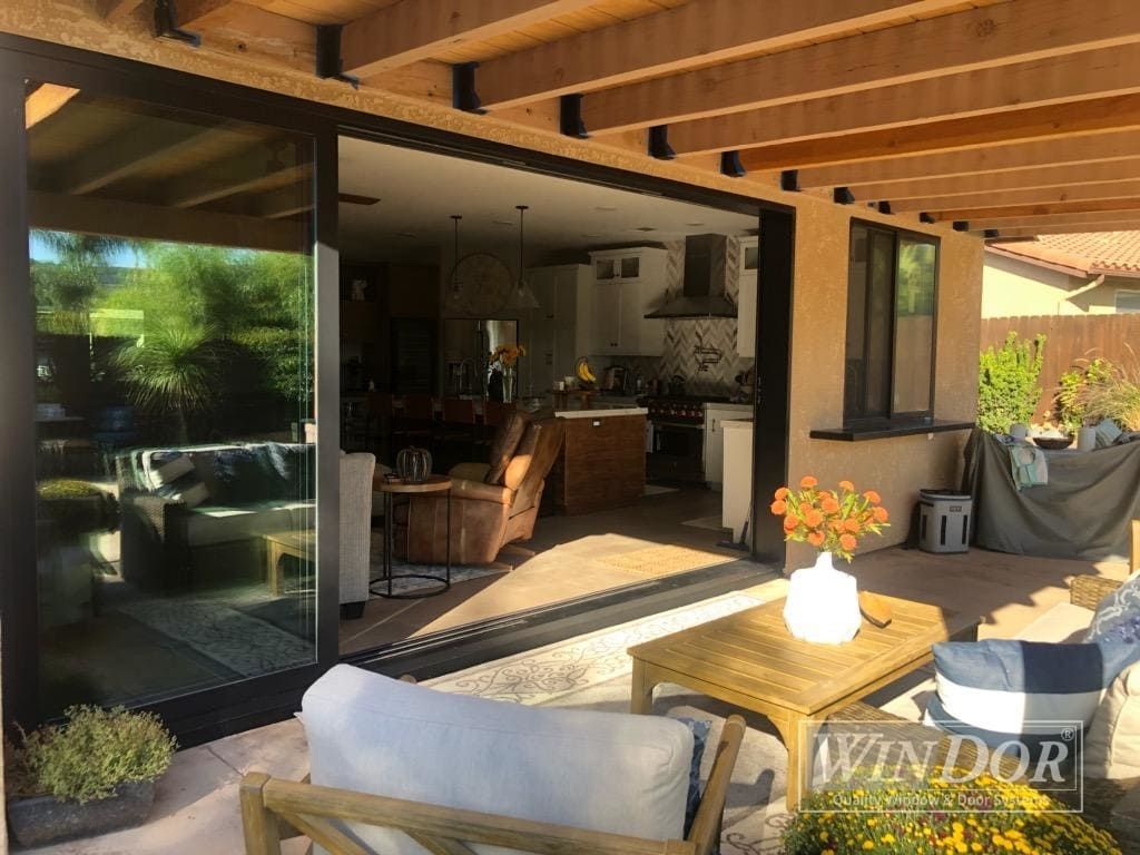 A living room with sliding glass doors leading to a patio.