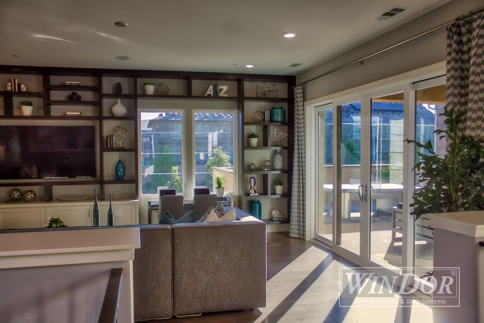 A living room with sliding glass doors and a tv