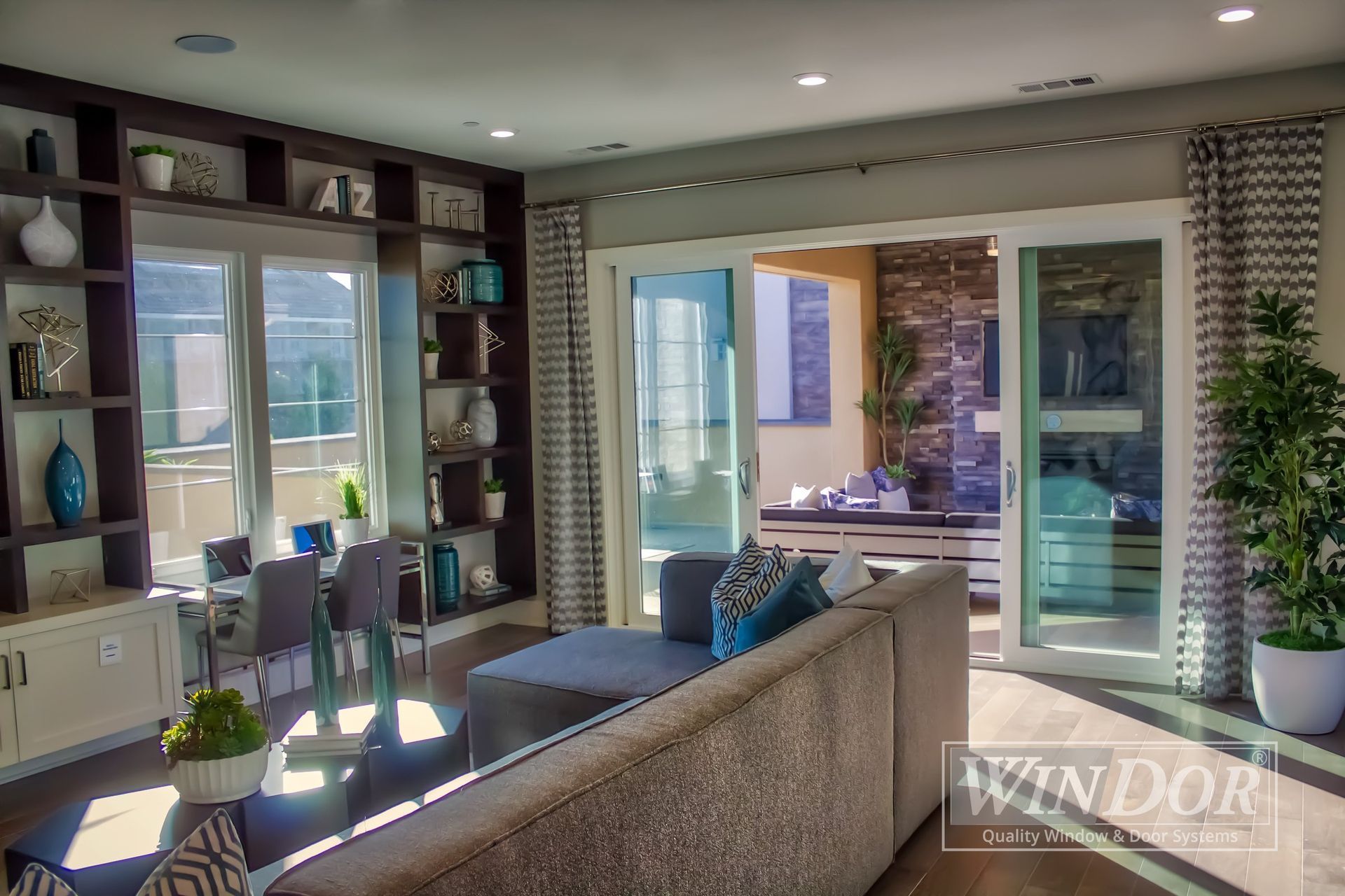 A living room with a couch and sliding glass doors
