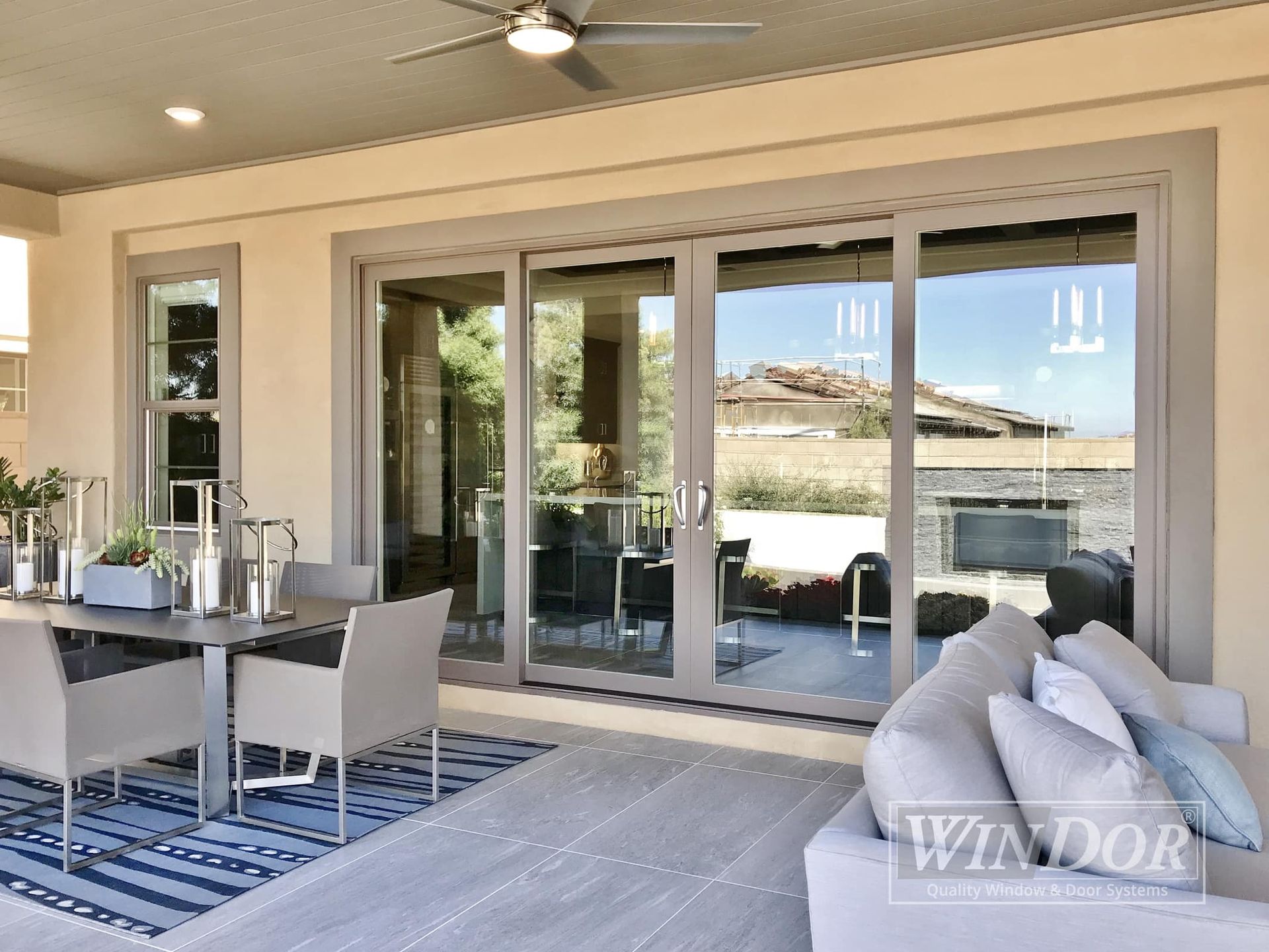 A patio with sliding glass doors and a ceiling fan