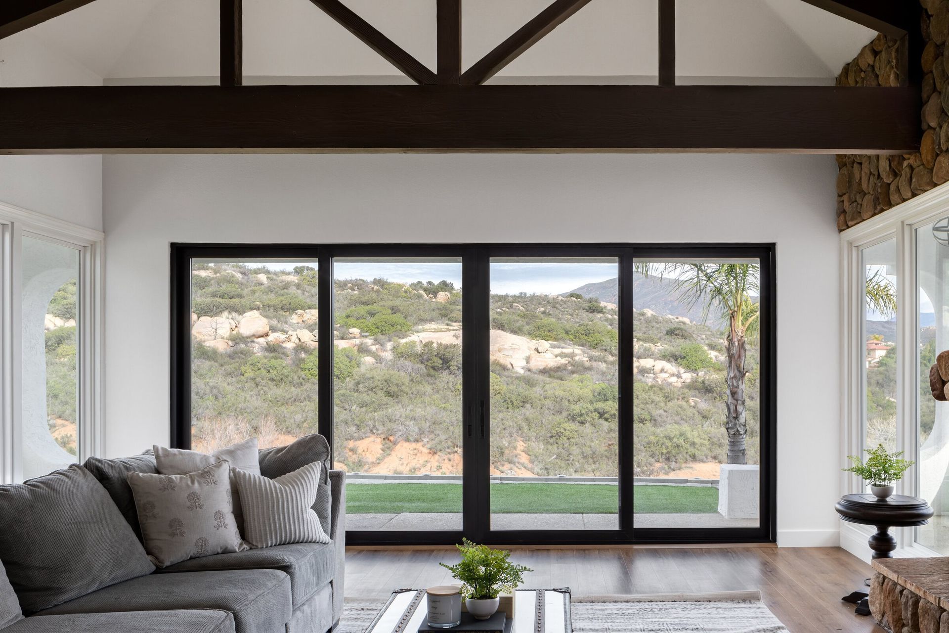 A living room with a couch , coffee table , and sliding glass doors.