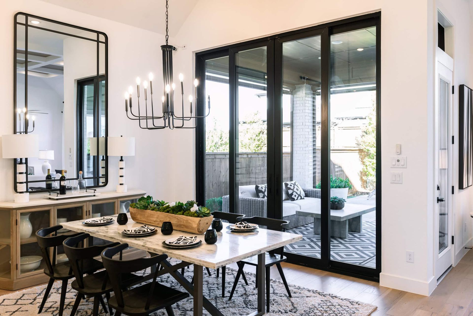A dining room with a table and chairs and a chandelier.