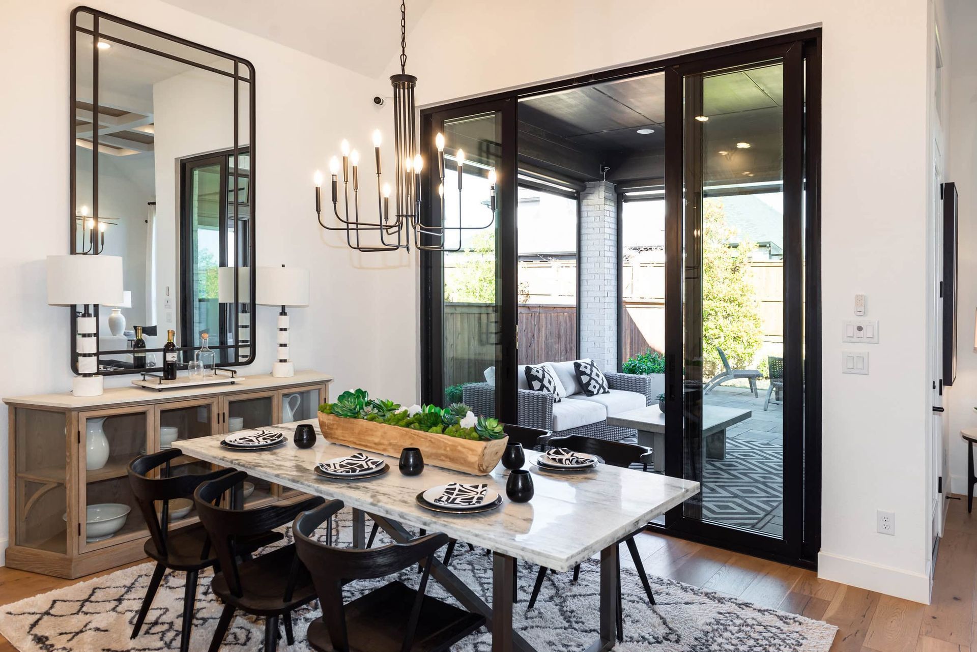 A dining room with a table and chairs and a chandelier.