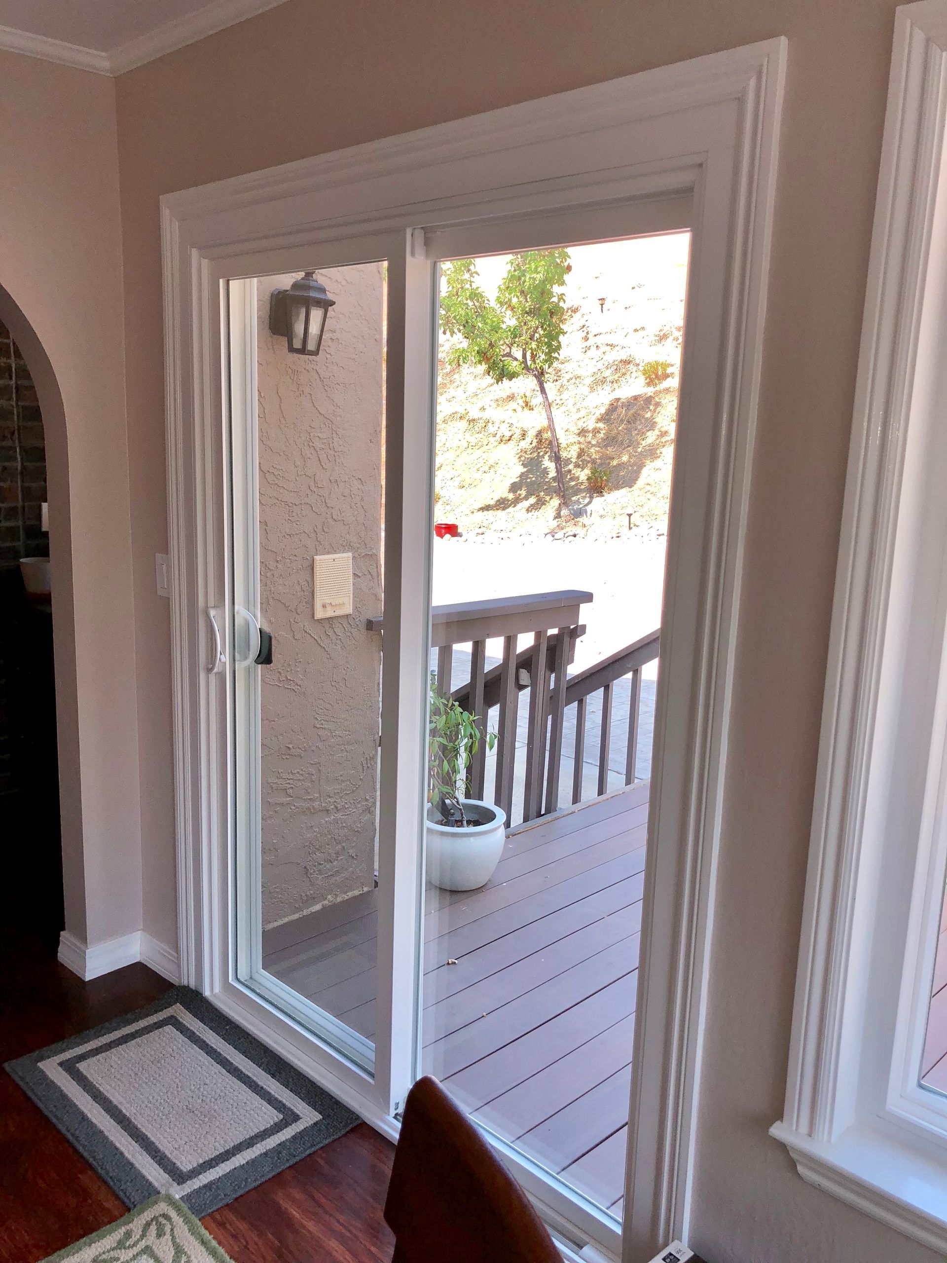 A room with a sliding glass door leading to a deck