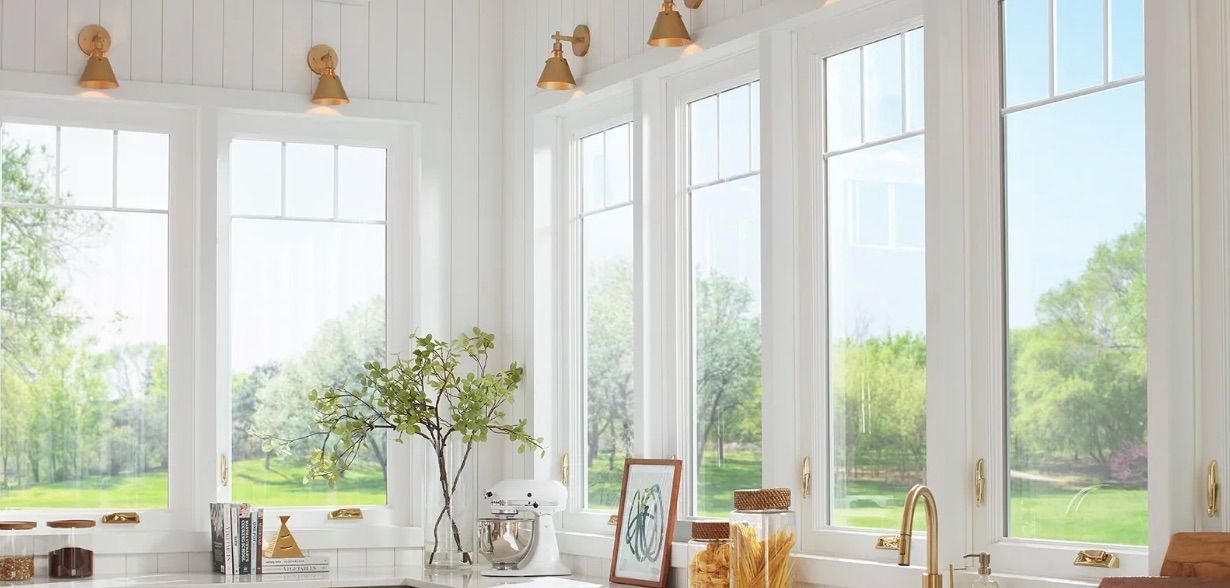 A kitchen with a lot of windows and a sink.