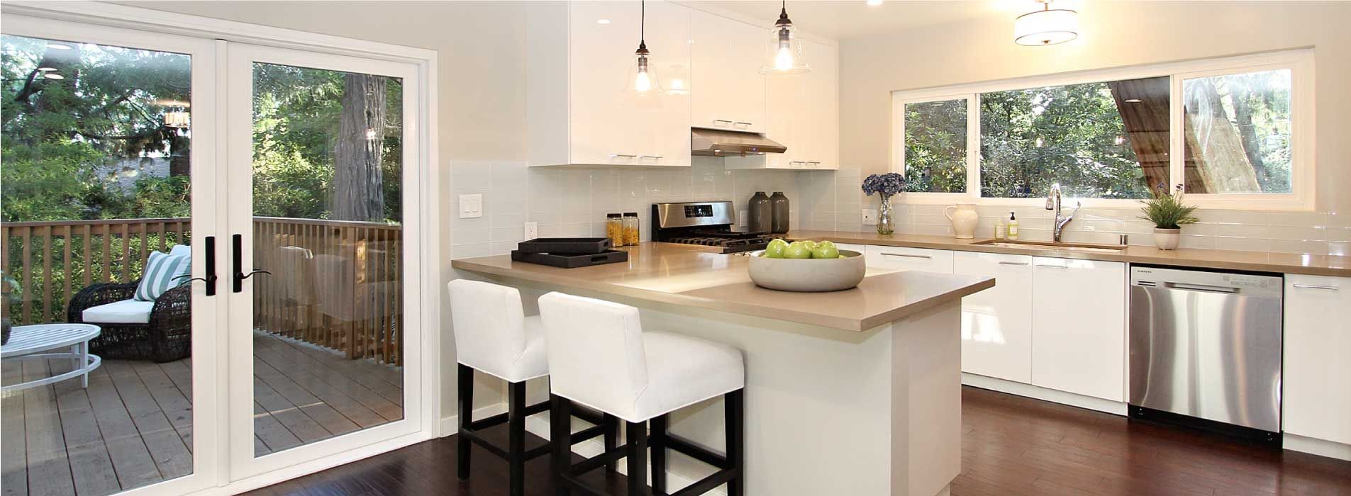 A kitchen with white cabinets and stainless steel appliances
