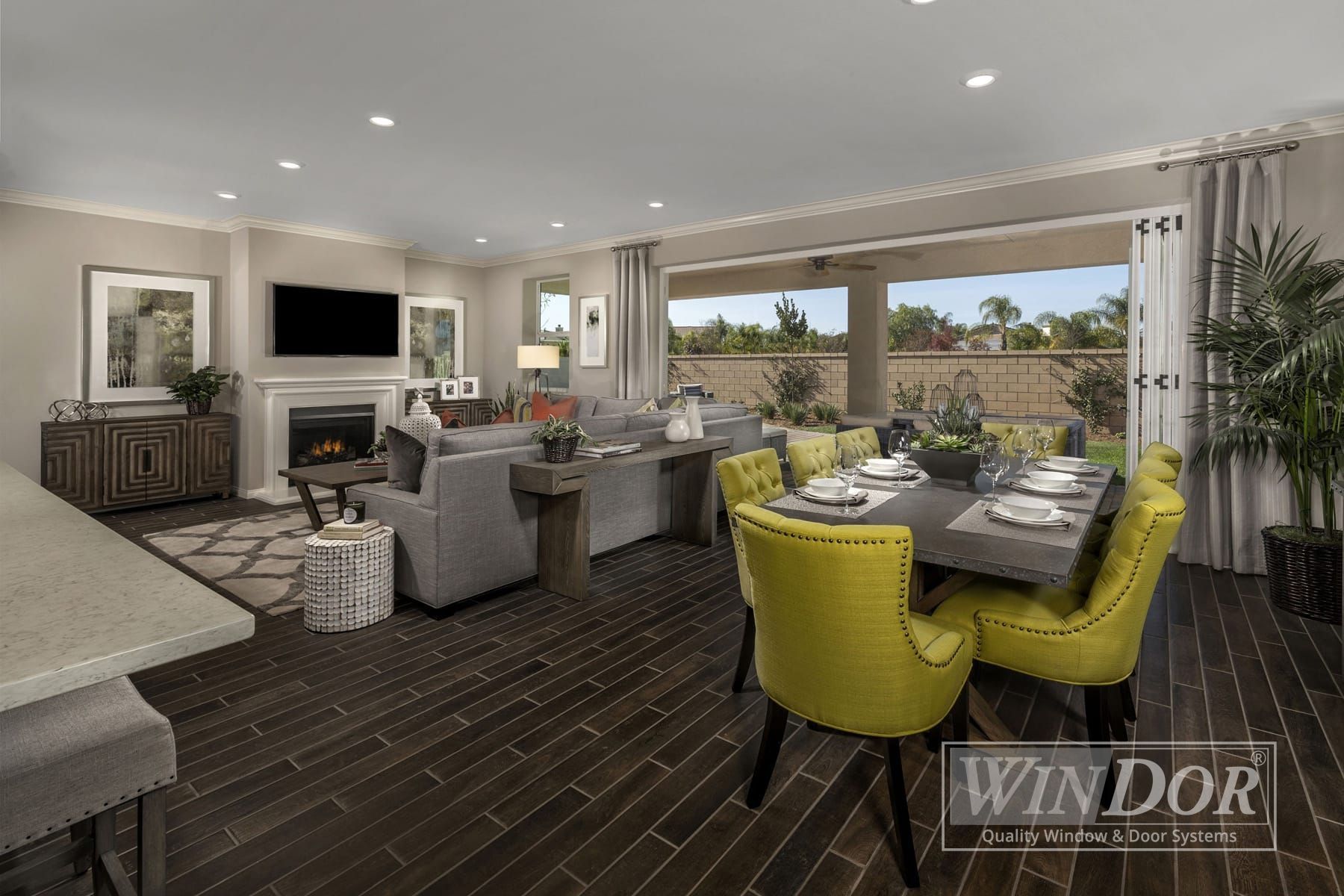 A living room with a dining table and chairs and a fireplace.