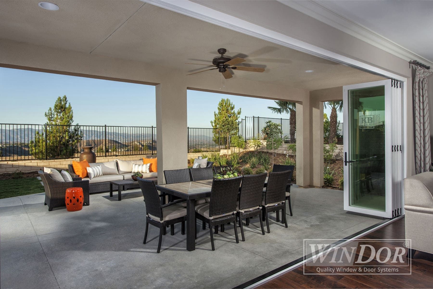 A living room with a dining table and chairs and a fireplace.
