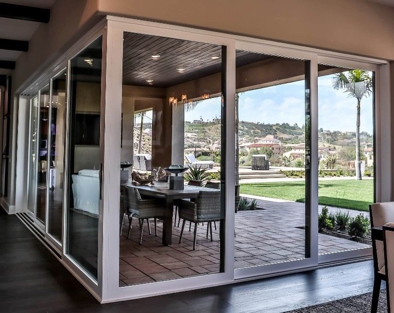 A dining room with sliding glass doors leading to a patio