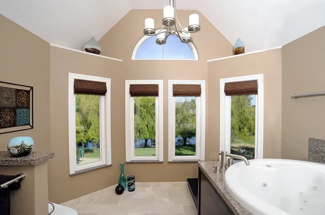 A bathroom with a jacuzzi tub and lots of windows