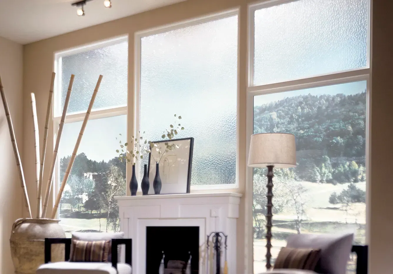A living room with a fireplace and lots of windows