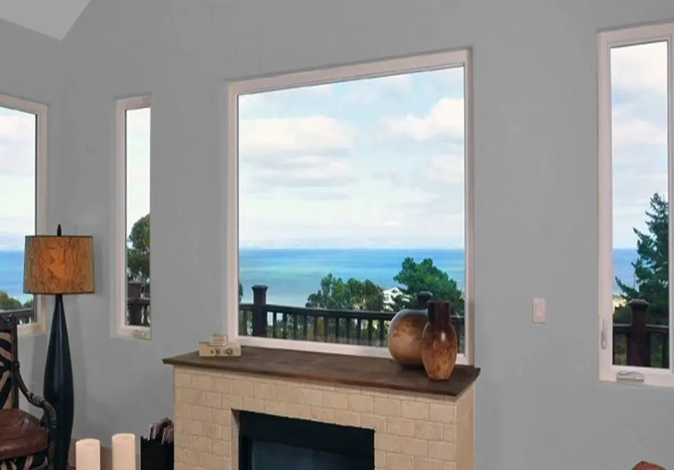 A living room with a fireplace and a view of the ocean