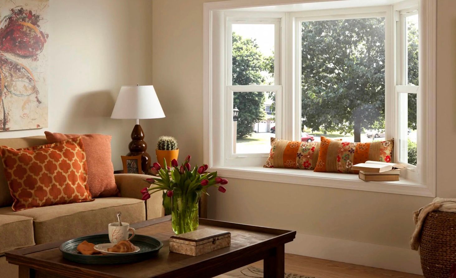 A living room with a large bay window and a couch.
