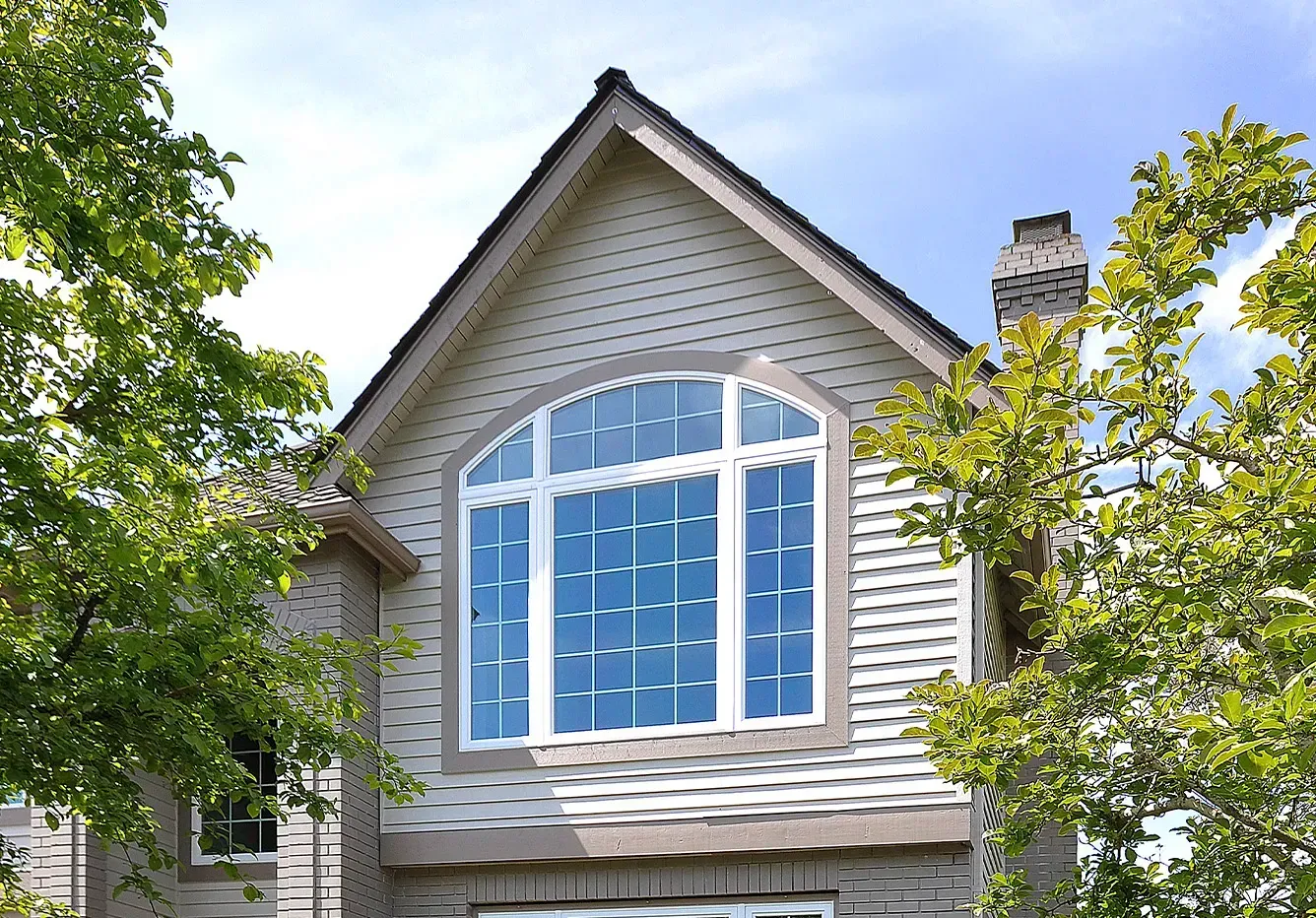 A house with a large window on the top of it