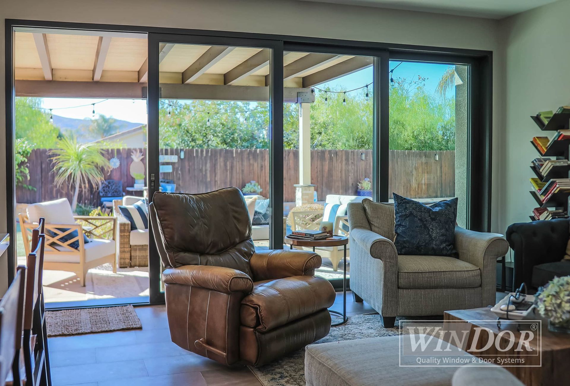 A living room with sliding glass doors that lead to a patio.