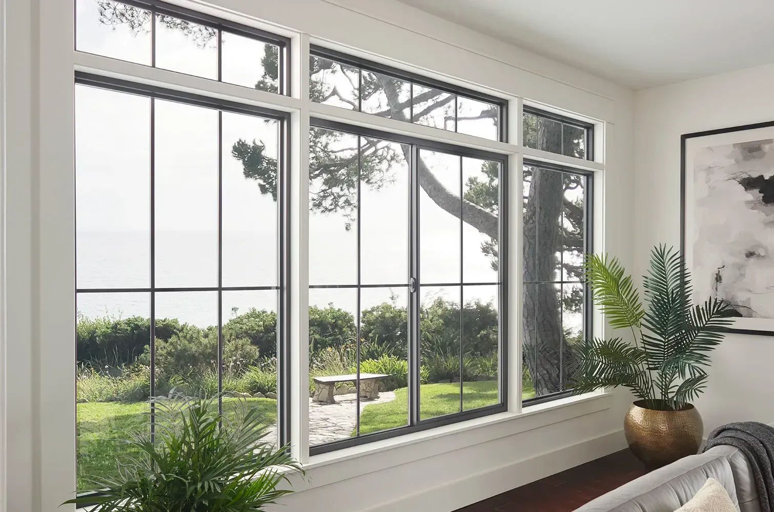 A white house with a large deck and a table and chairs on it