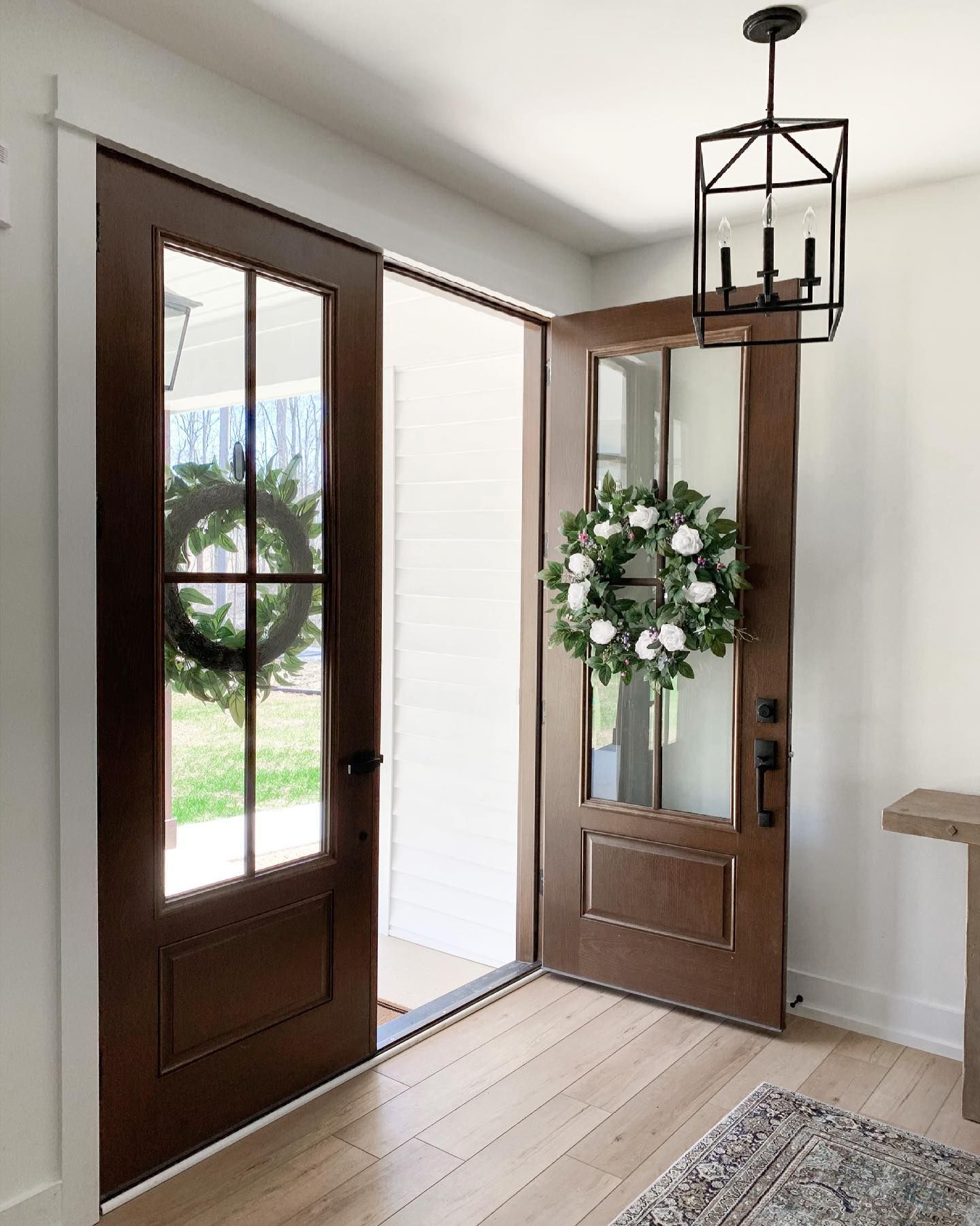 A wooden door with a wreath on it in a hallway.