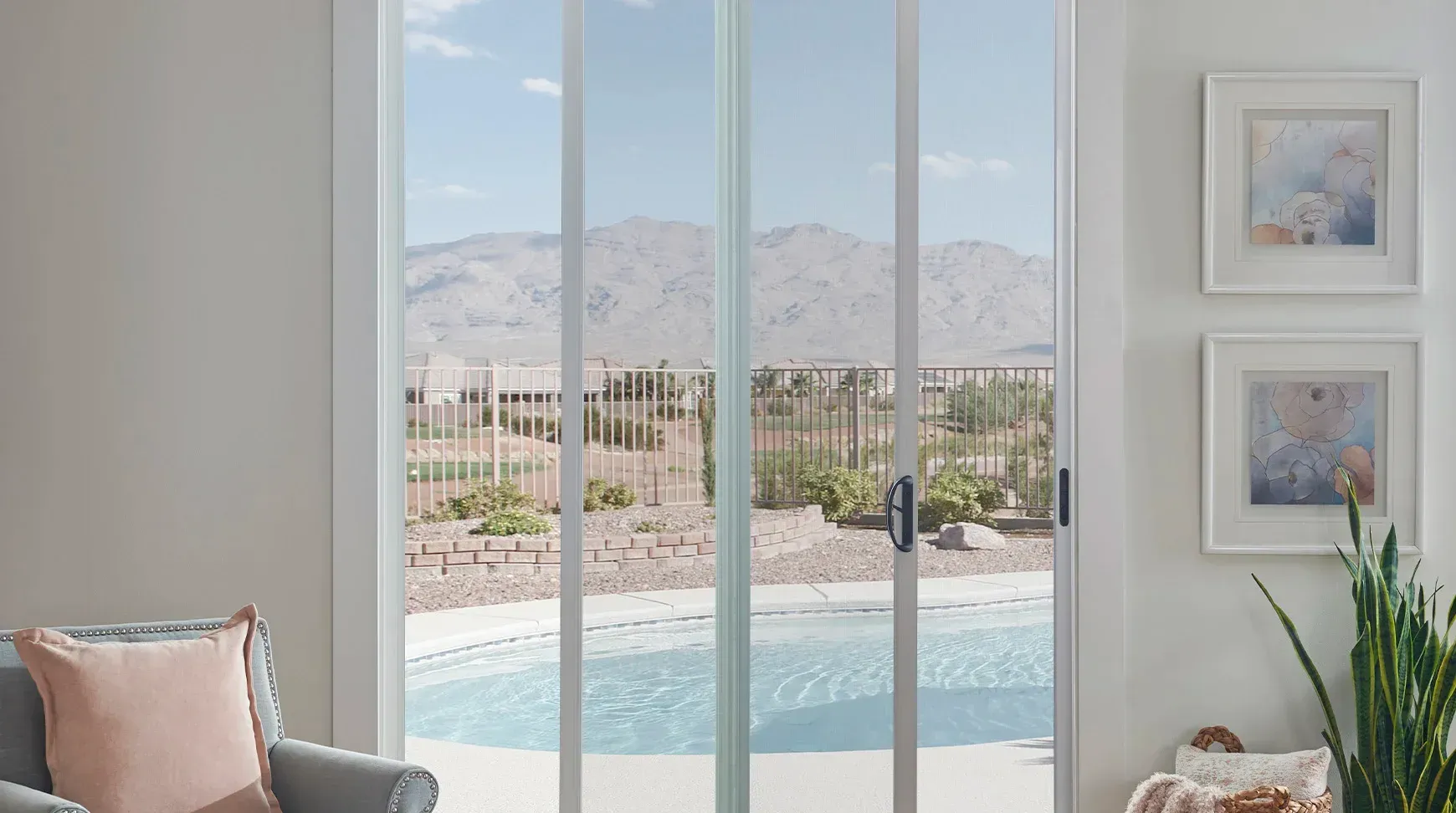 A living room with a sliding glass door leading to a pool.