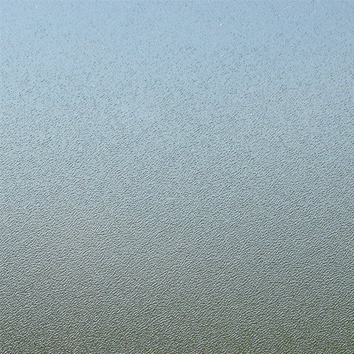 A close up of a frosted glass window with a blue sky in the background.