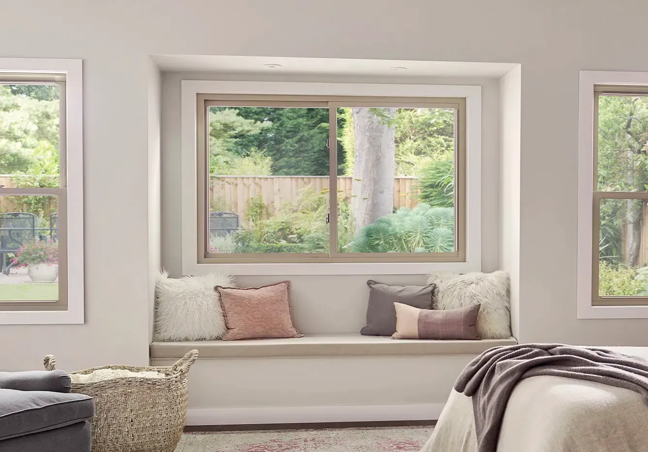 A bedroom with a window seat and a bed.