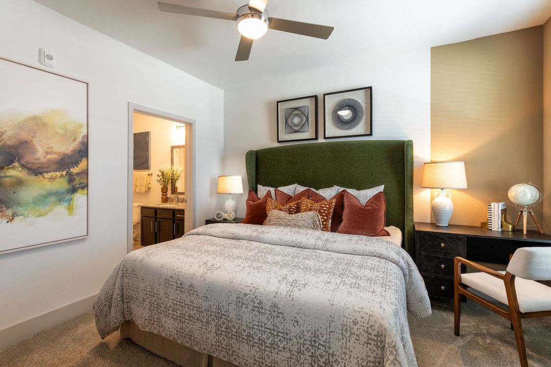 A bedroom with a king size bed and a ceiling fan  at EightyOne10 Blue Goose.