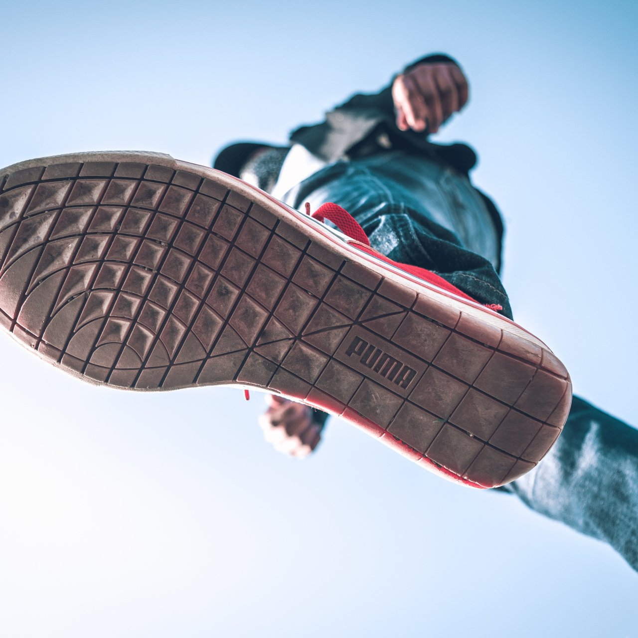 A person is wearing a pair of puma shoes