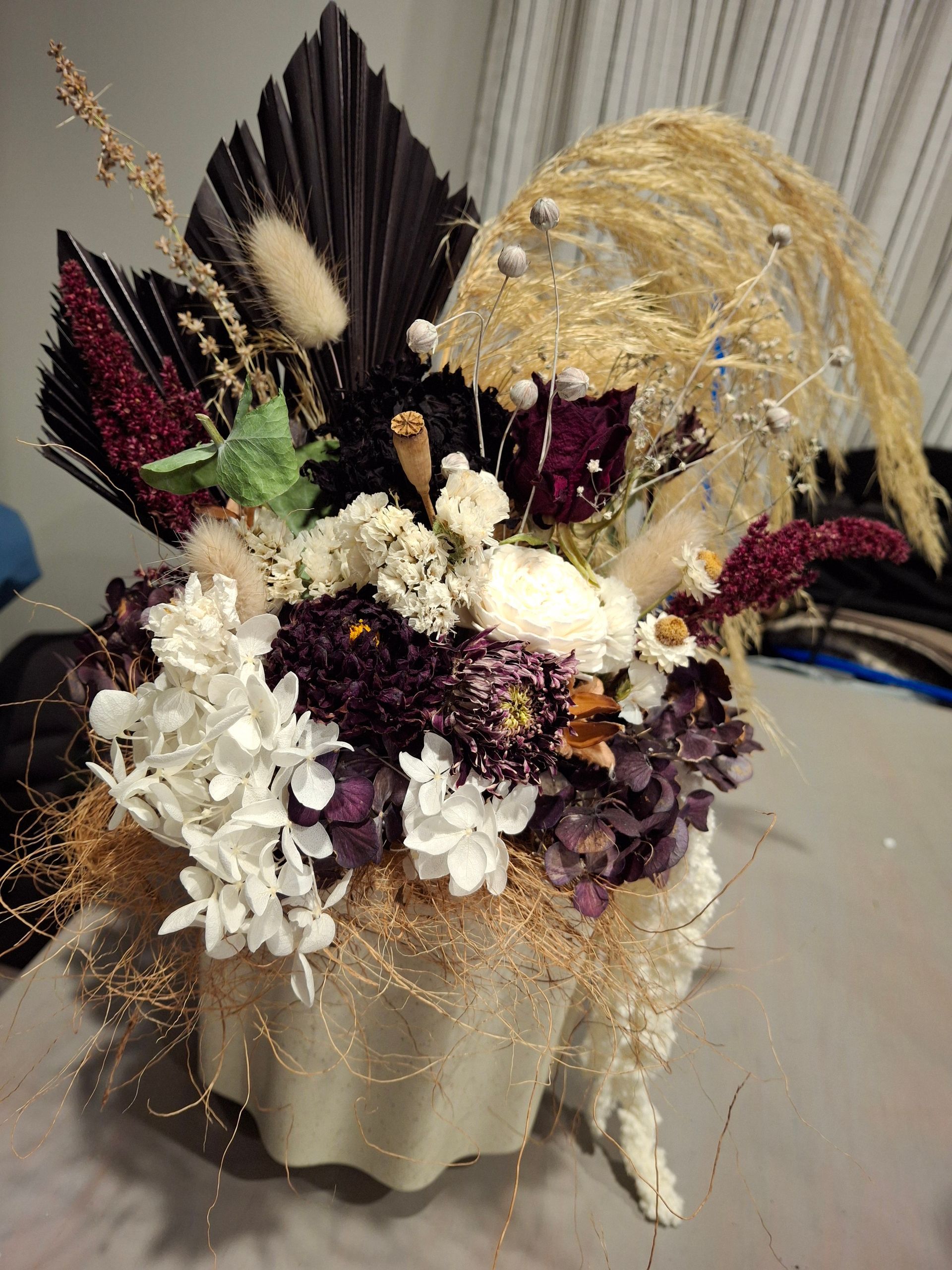 A beautiful dried flower arrangement in deep red tones